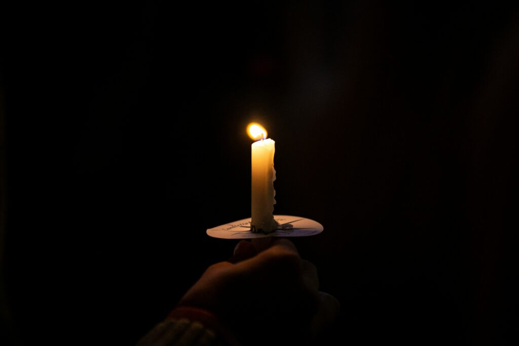 Candle illuminates the dark night