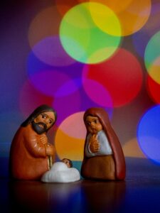 The mystery of Christmas with Joseph, Mary, Baby Jesus and bright, colored circles of lights behind them